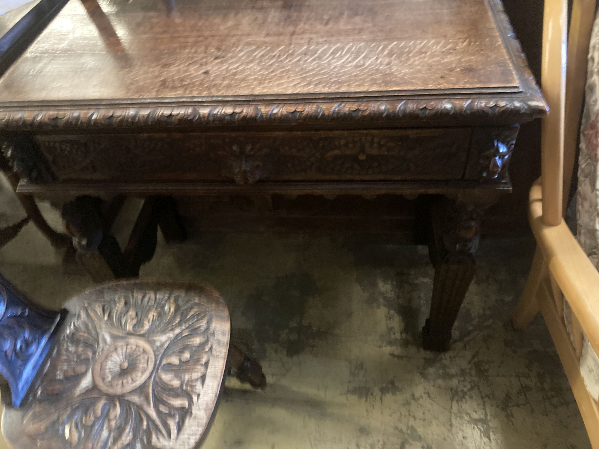 A late 19th century Flemish carved oak side table, width 88cm, depth 42cm, height 76cm, together with a carved oak spinning chair